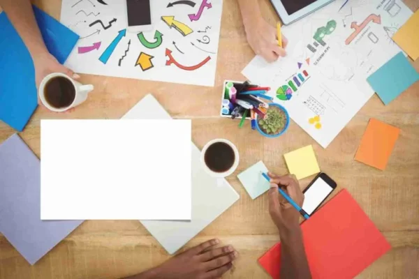 Overhead view of a team working through brand ideas with notes and sketches