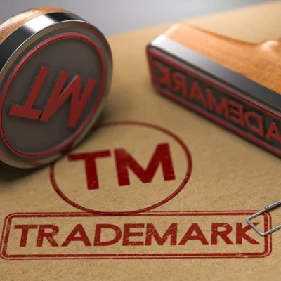 Rubber stamp printing the word Trademark on paper